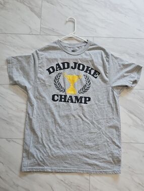 Celebrate It Gray "Dad Joke Champ" Short Sleeve Tee with Yellow Trophy Graphic